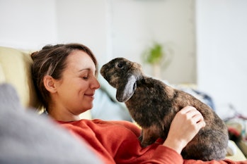 Woman cuddling rabbit