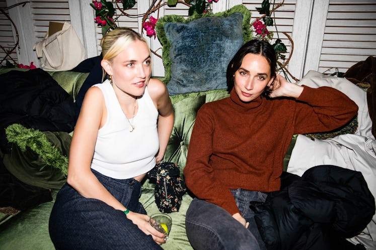 Rebecca Dayan and her friend sitting on a couch