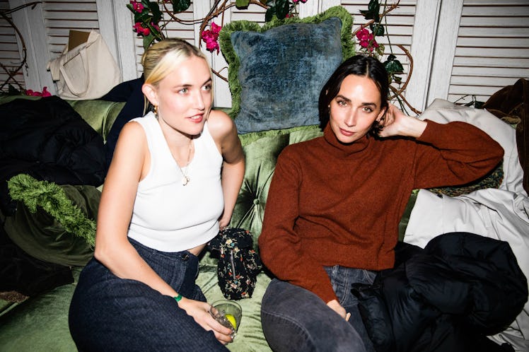 Rebecca Dayan and her friend sitting on a couch