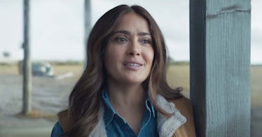 Salma Hayek in Eternals as Ajak in a denim shirt and brown vest looking into the distance 