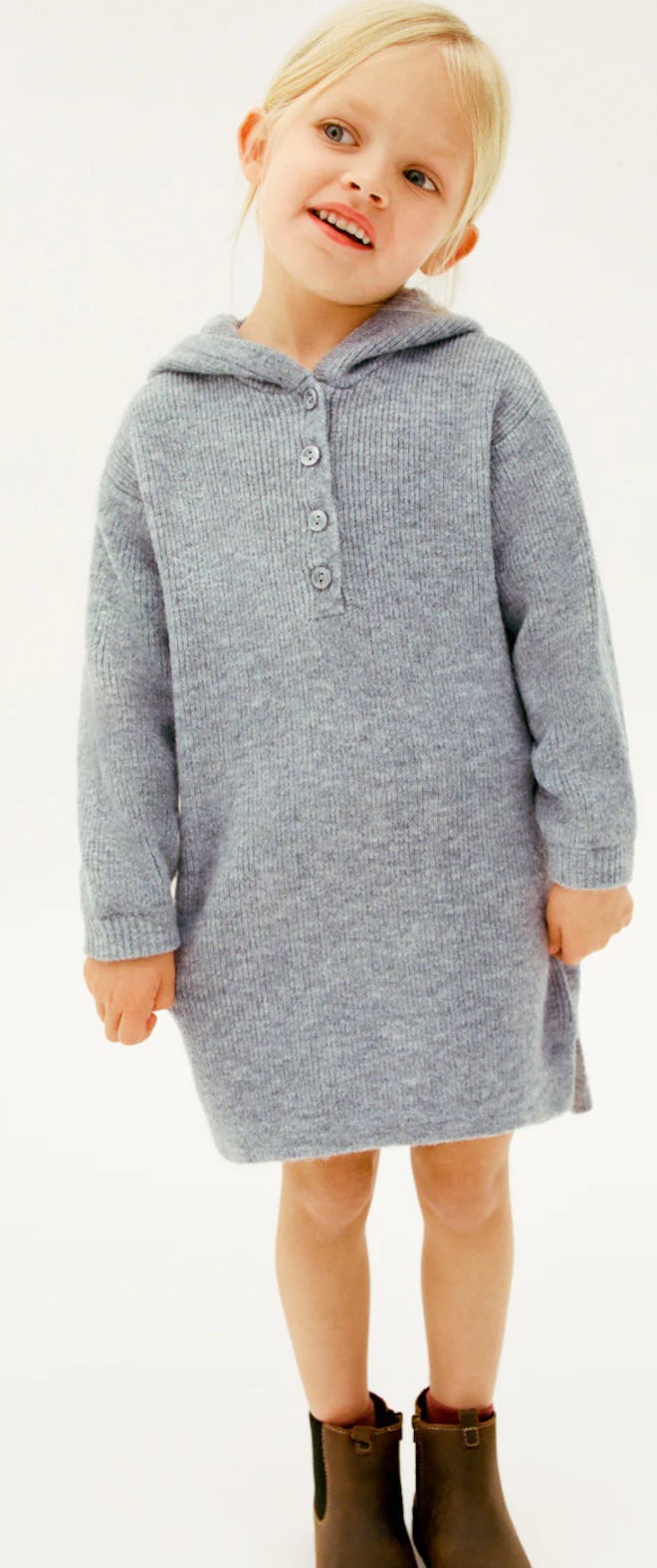 Image of a little girl wearing a gray hooded sweater dress.