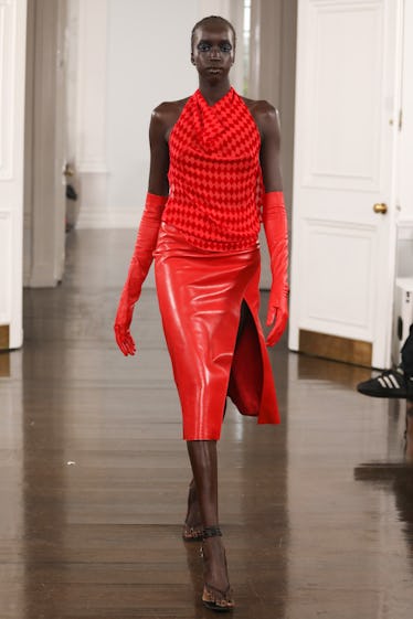 A model walks the runway at the Maximilian show during the Fashion East show