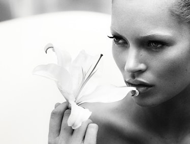 Kate Moss holding a white lily flower