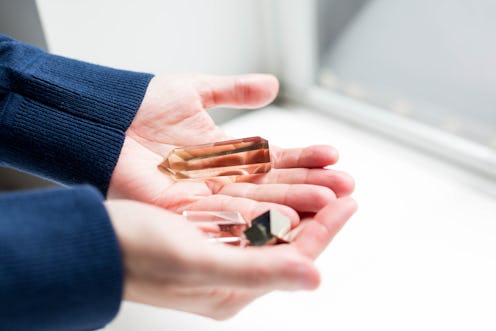 A person holds a handful of crystals for manifesting on 11/11, one of the luckiest days of the year.