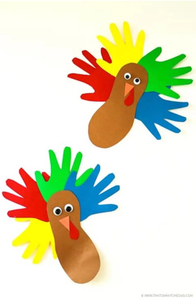 Colorful turkey craft for kids with cutouts of hands and feet