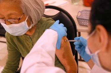 An elderly woman receives a Pfizer COVID-19 booster shot at a clinic in San Rafael, California.