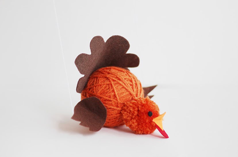 An orange and brown turkey puppet 