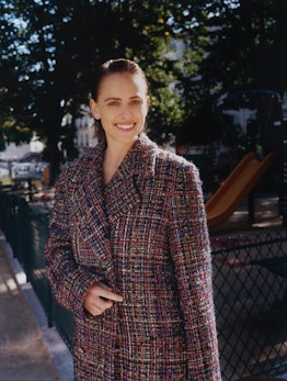 Pauline Chalamet wears Chanel coat.