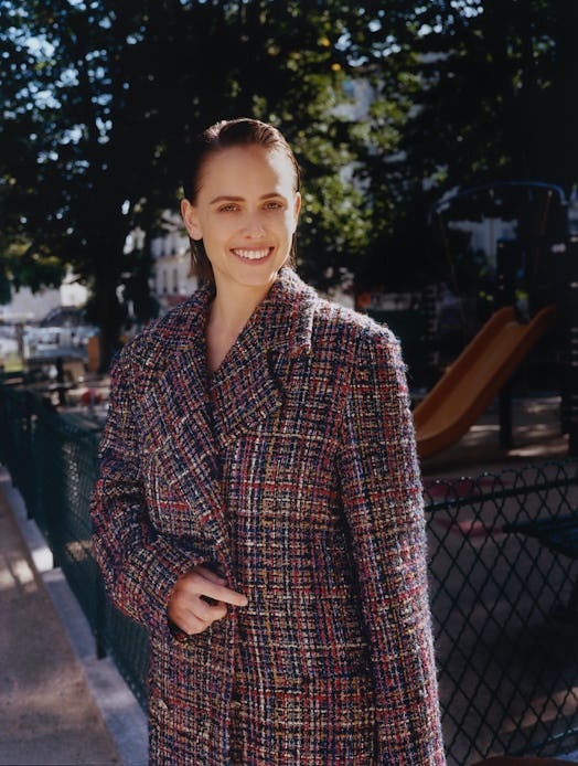 Pauline Chalamet wears Chanel coat.