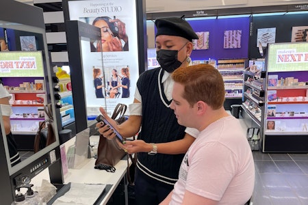 A makeup artist walking a customer through product options.