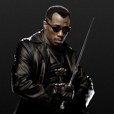 A promotional image for Blade 2 with Wesley Snipes in a black leather coat and black sunglasses