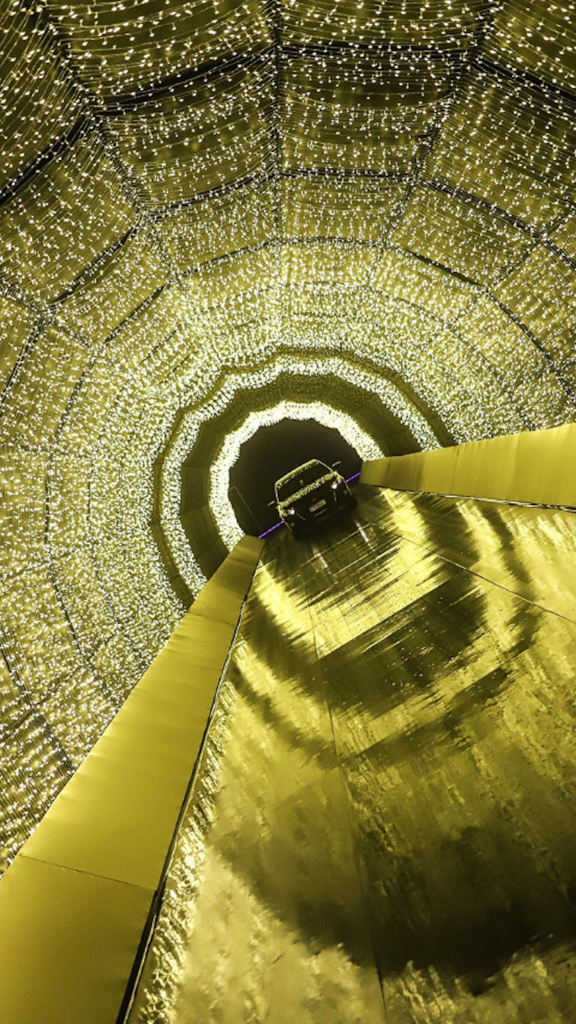 A family observes the Christmas lights as they pass through a drive-thru Christmas 2021 experience.