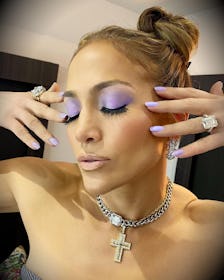 Jennifer Lopez showing purple eyeshadow and nails