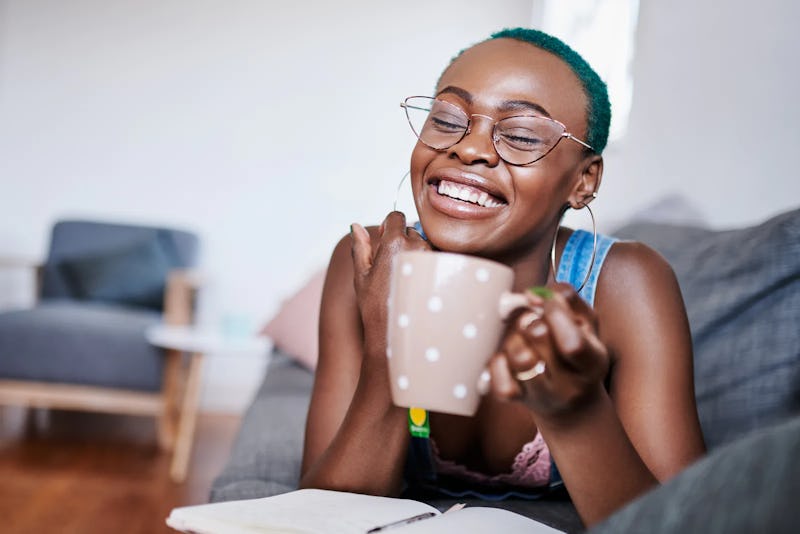 A woman with green hair drinks tea. Here's your daily horoscope for Dec. 2, 2021.