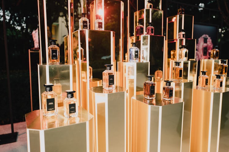 Guerlain perfumes presented on golden podiums at the ICA sculpture garden 
