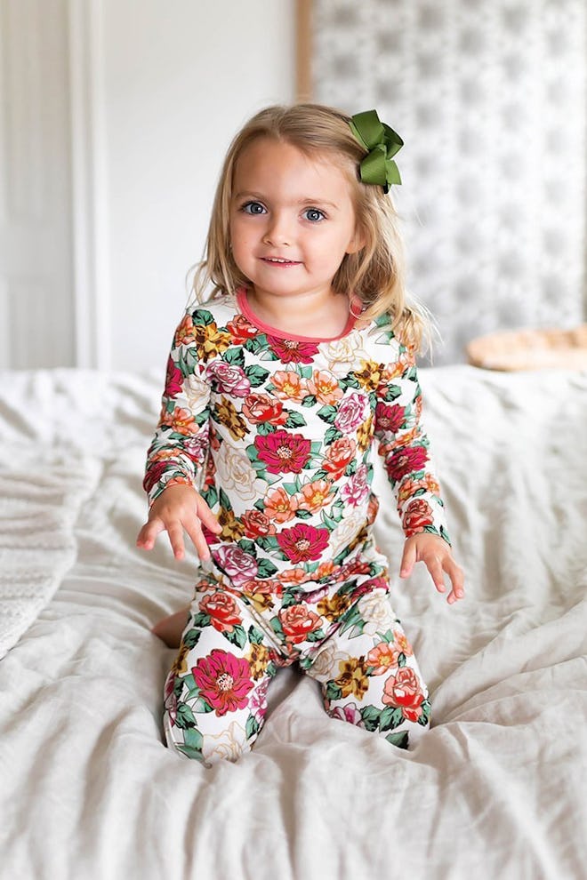 Little girl modeling long-john pjs with floral print