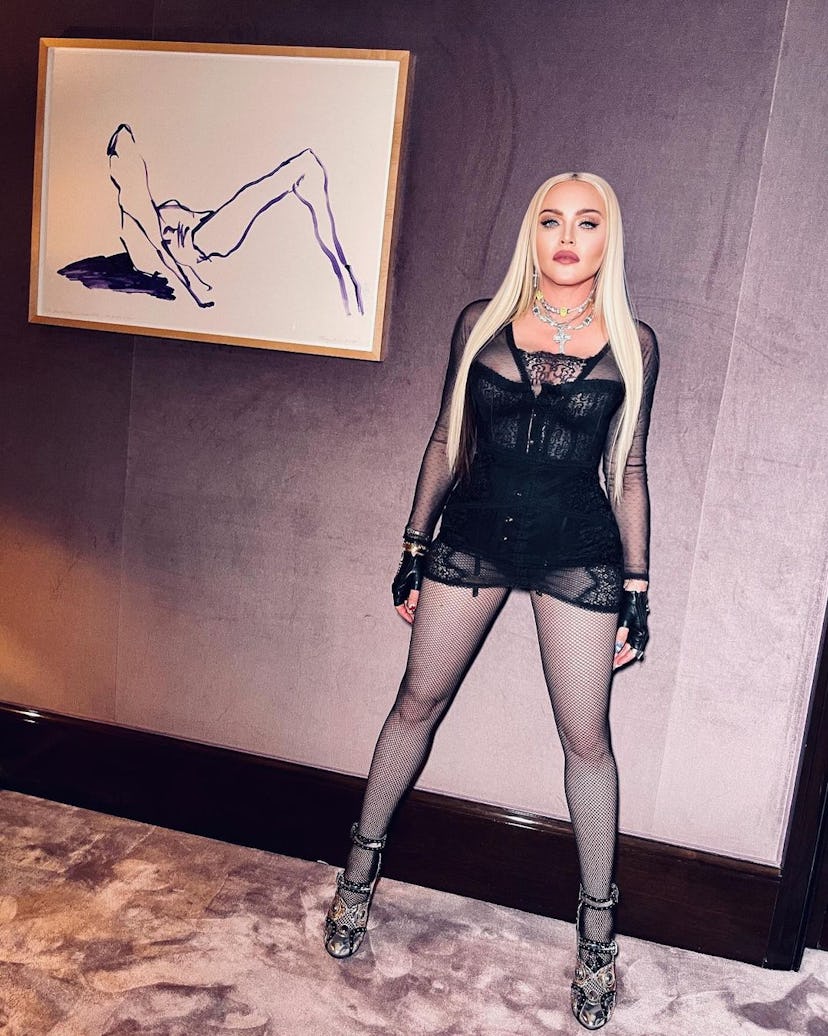 Madonna posing next to a Tracy Emin painting