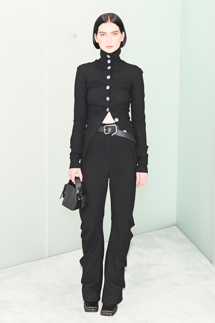 Meadow Walker posing in a black blazer and pants combination