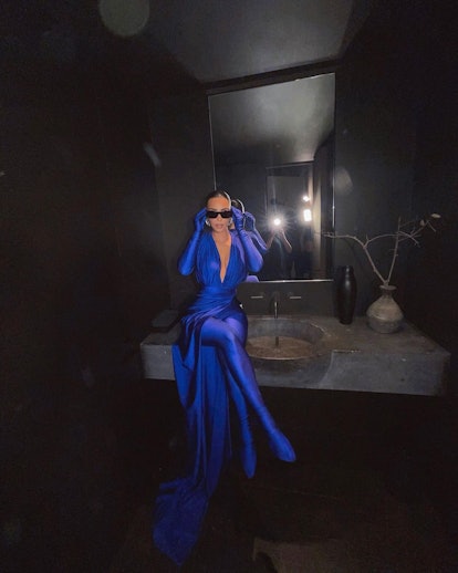 Kim Kardashian wearing sunglasses and a blue ensemble by Balenciaga
