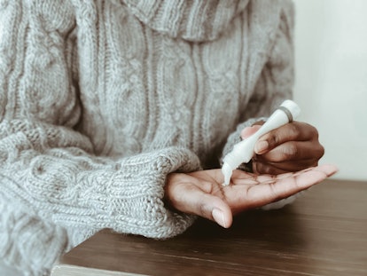 Woman using colloidal oatmeal cream 