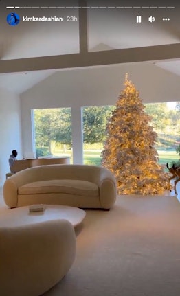 Philip Cornish plays the piano beside a towering Christmas tree in Kim Kardashian West's living room...