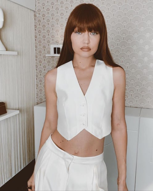 Gigi Hadid wearing a white waistcoat and trousers.