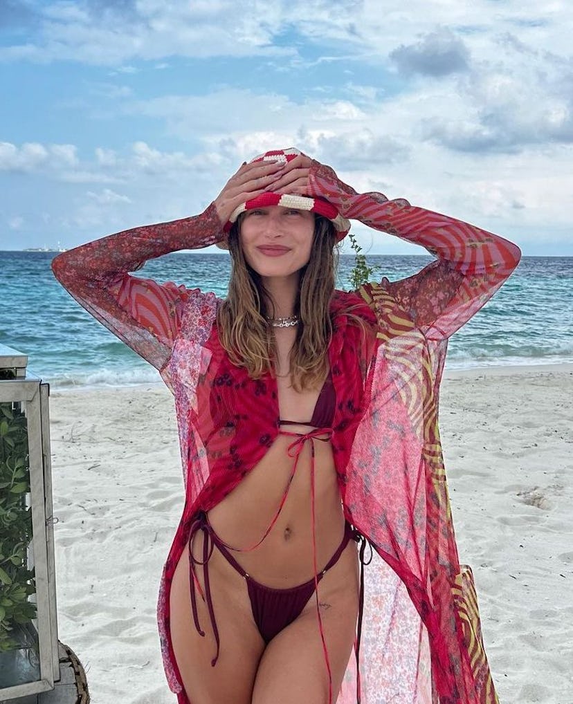 Hailey Bieber with her hands on her crochet bucket hat
