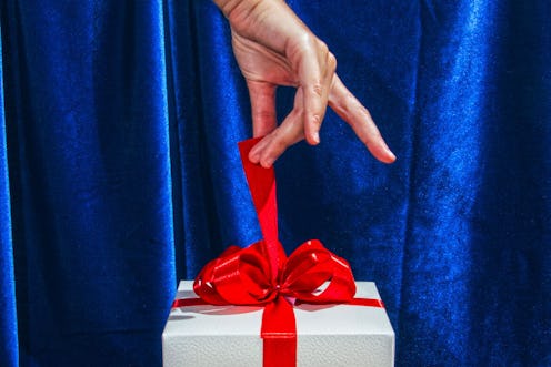 A woman's hand unwraps a present. A lifelong last-minute gift-giver shares supply chain proof holida...
