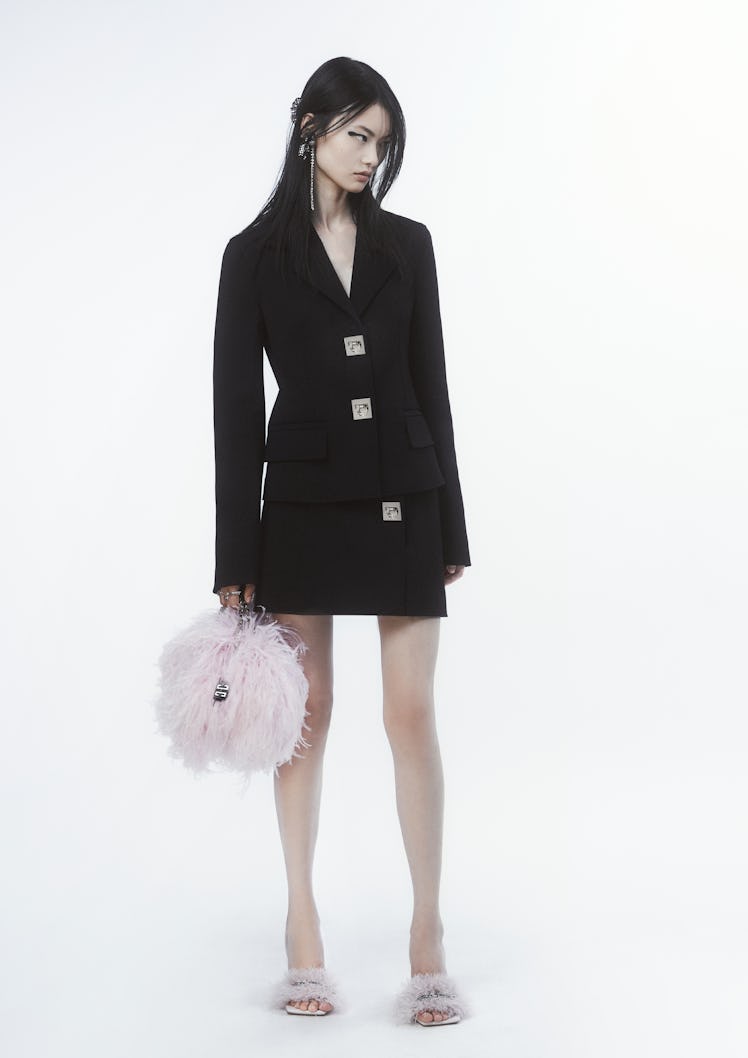 Givenchy black suit look with pink feathered bag