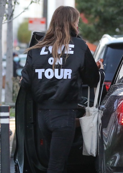 Olivia Wilde wears Harry Styles 'Love On Tour' jacket.
