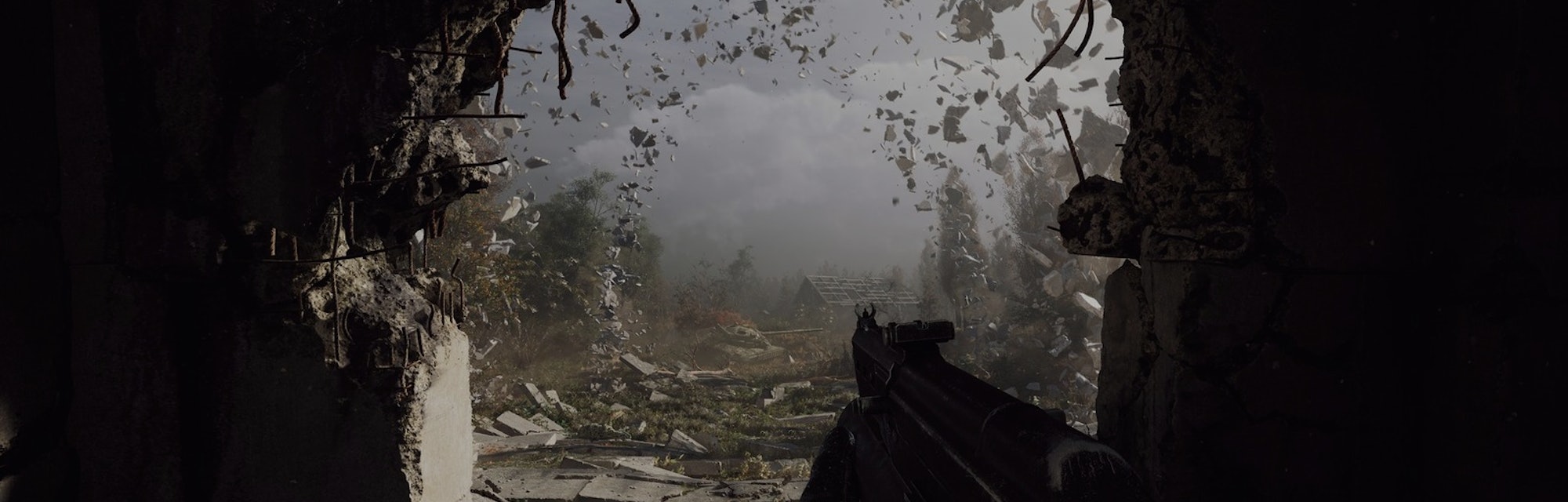 first-person view holding a gun with rocks flying and gritty farm landscape