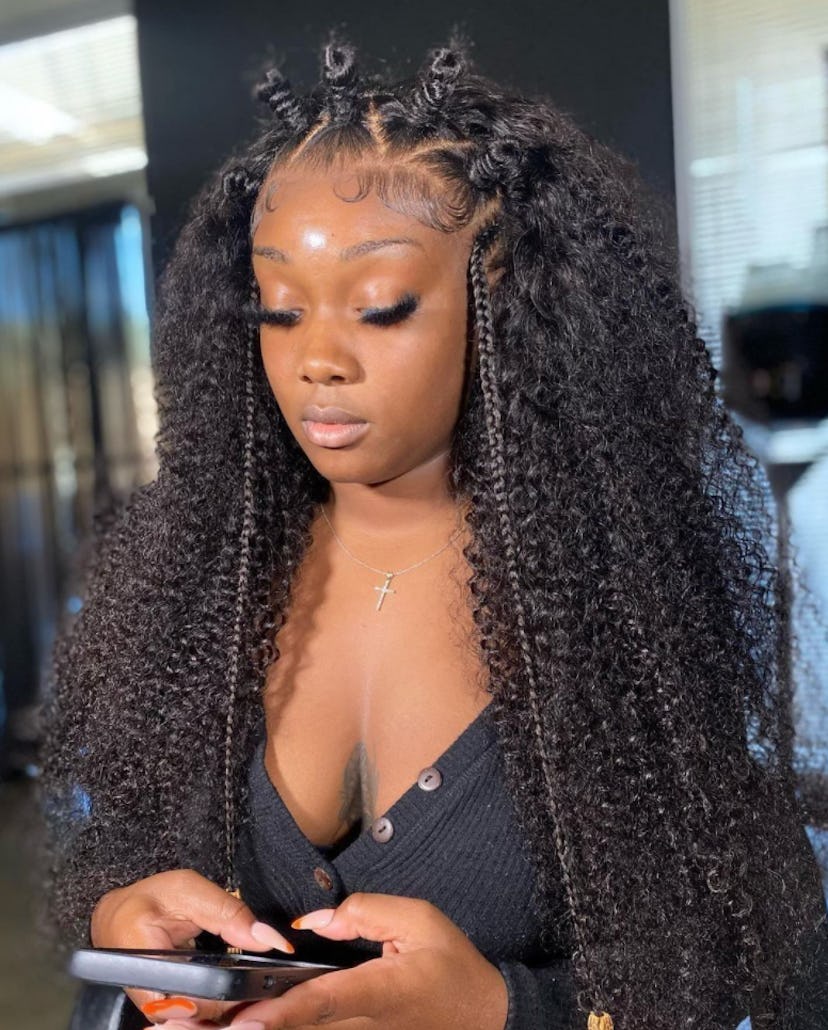 Woman with long curly wig with braids and bantu knots
