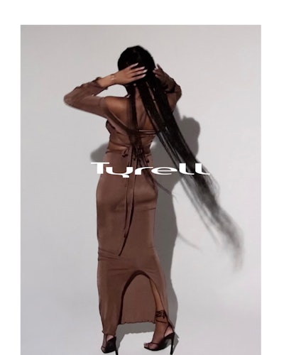 Model wears a brown dress by TYRELL.