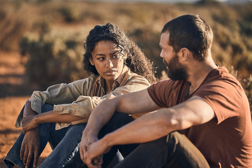 Jamie Dornan sitting in the desert in The Tourist