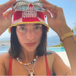 Dua Lipa wearing a crochet hat and jewelry.