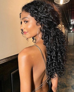 woman with curls looking over shoulder