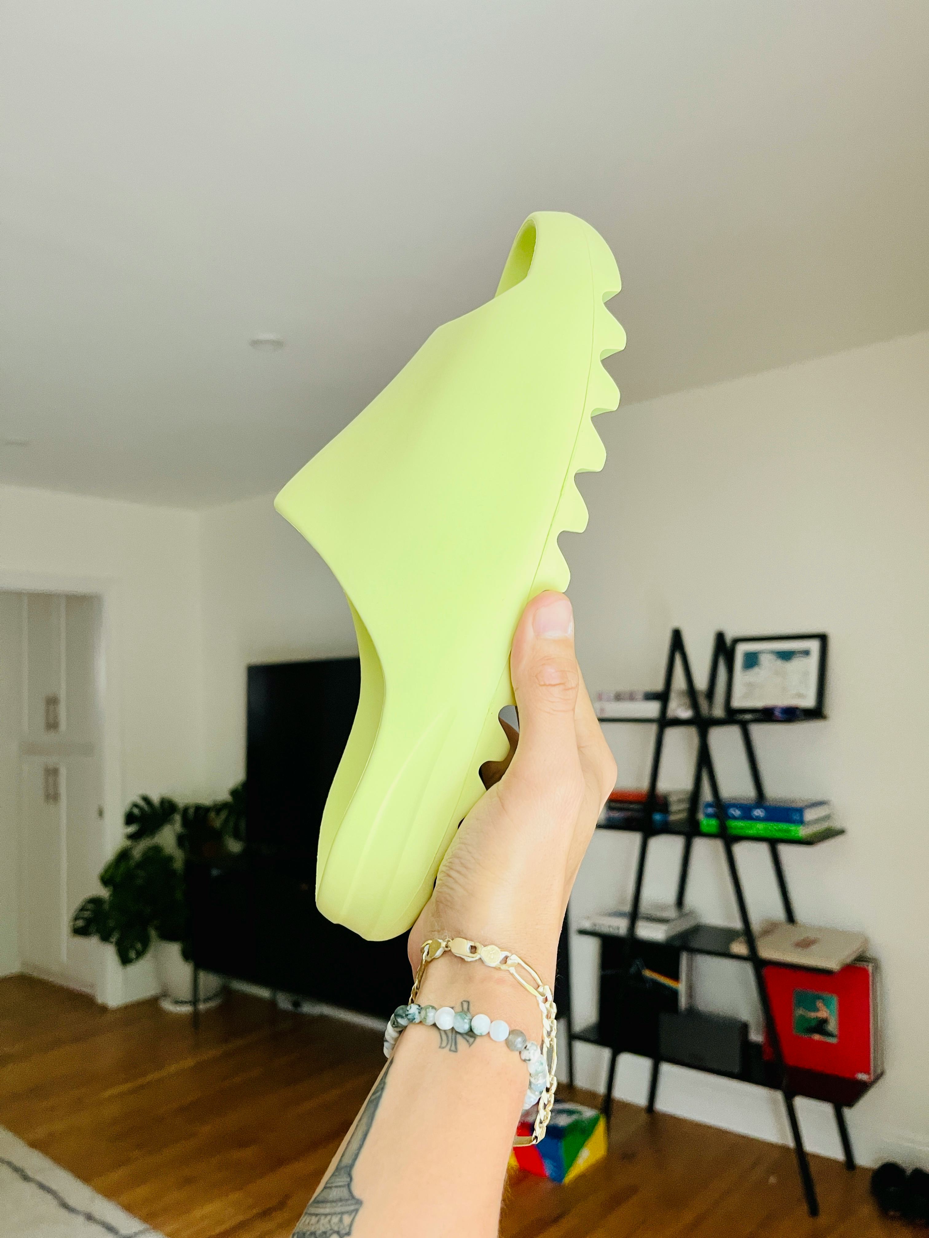 green yeezy slides on feet