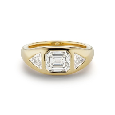 An emerald-cut diamond engagement ring with triangle side stones by Brent Neale