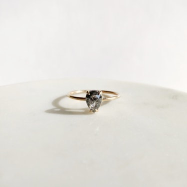 A pear-shaped salt and pepper diamond engagement ring by A.M. Thorne