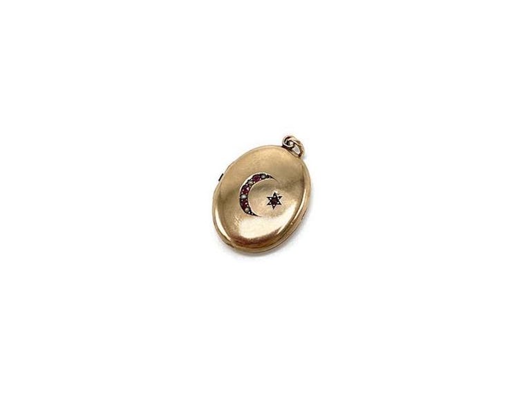gold oval locket with a star and moon by Devereux