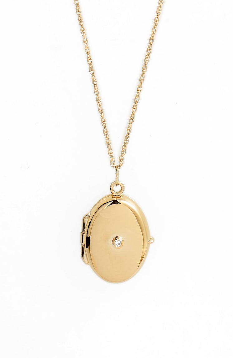 Yellow gold oval locket with a diamond by Jennifer Zeuner