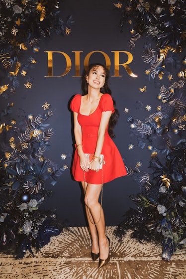 Christian Serratos in a red mini dress at the Dior party