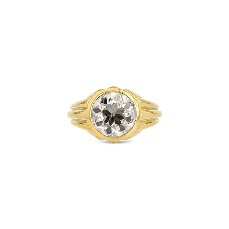 A round brilliant diamond engagement ring in a chunky yellow gold setting by Grace Lee