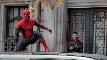 Spider-Man standing on a roof of a car
