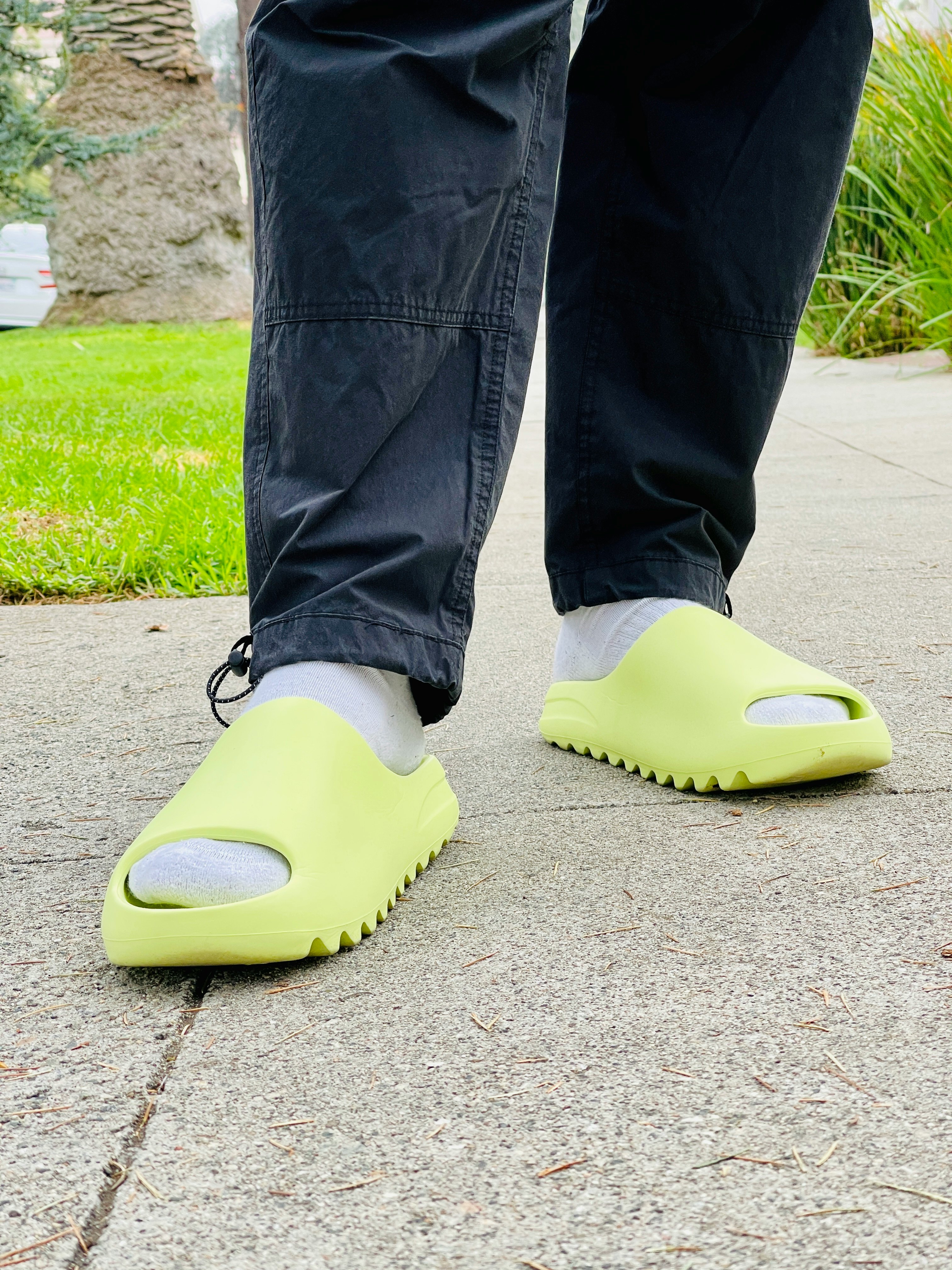 green glow yeezy slides on feet