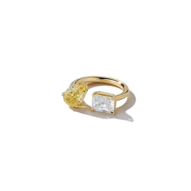An open toi et moi engagement ring featuring a pear-shaped canary diamond and radiant white diamond ...