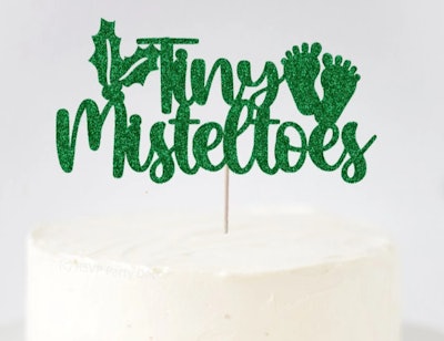 Christmas cake topper that says "Tiny Mistletoes" 