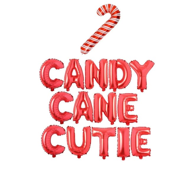 Balloon garland that reads "Candy Cane Cutie" with a candy cane shaped balloon