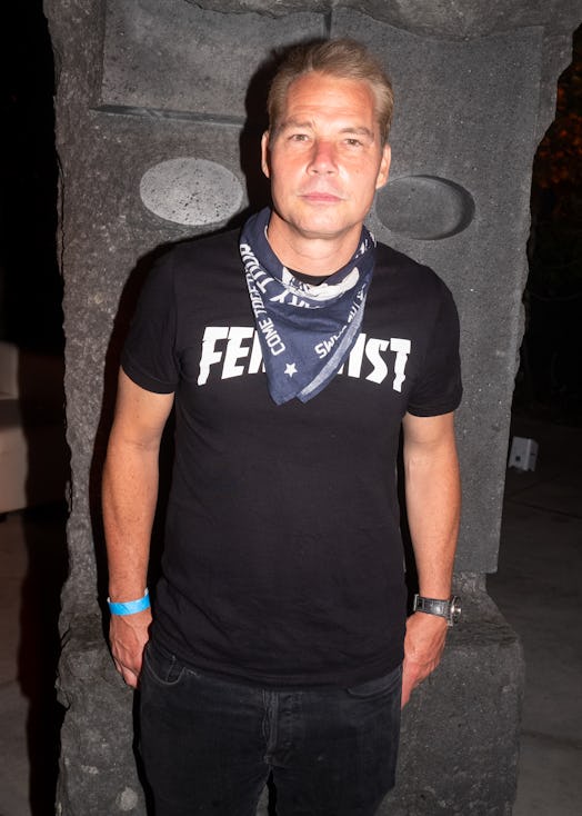 Shepard Fairey in a black shirt and grey bandana around his neck 