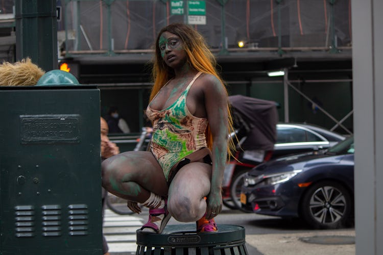 Crackhead Barney atop a garbage can